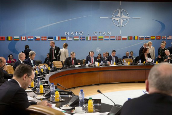 British Foreign Minister William Hague (rear L) sits next to U.S. Secretary of State John Kerry during a NATO-Ukraine commission meeting at NATO headquarters in Brussels April 1, 2014. NATO suspended all practical cooperation with Russia on Tuesday in pro
