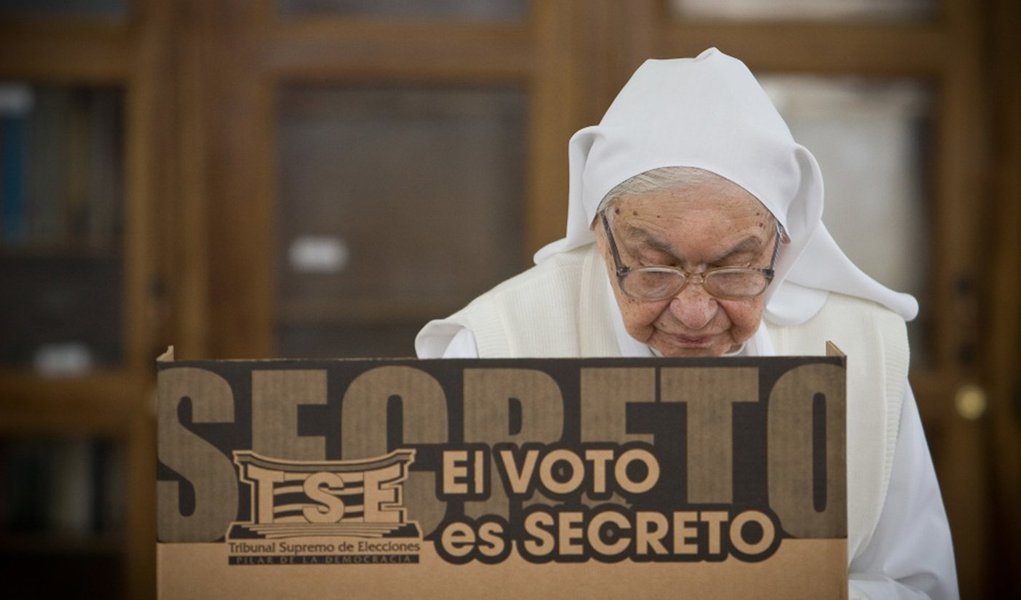 A nun voting at Carlos Maria Ulloa Nursing Home, Guadalupe