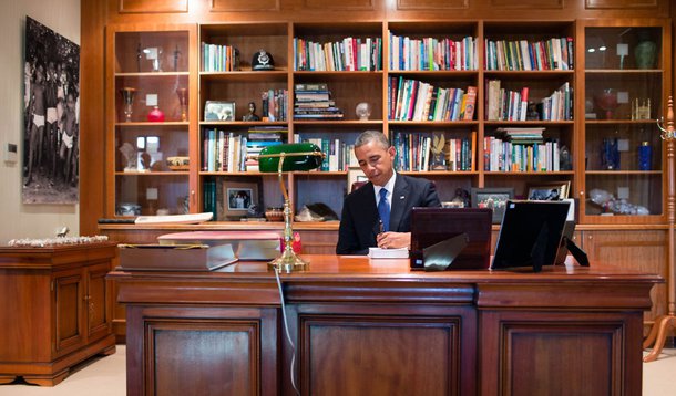 President Barack Obama signs a copy of  former South African President Nelson Mandela's book "Conversations with Myself" while visiting Mandela's office at the Nelson Mandela Centre of Memory in Johannesburg, South Africa, June 29, 2013. President Obama w