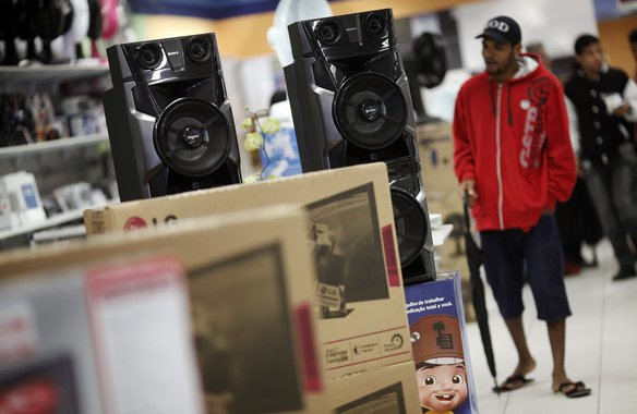 A man walks past speakers at a Casas Bahia store in Sao Paulo February 7, 2013. Brazil's inflation accelerated to the fastest rate in nearly eight years in January, raising bets of an interest rate hike this year that could complicate the government's dri