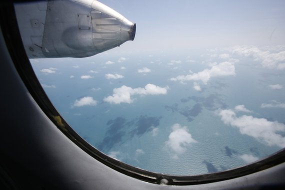 Clouds hover outside the window of a Vietnam Air Force search and rescue aircraft An-26 on a mission to find the missing Malaysia Airlines flight MH370, off Vietnam's Tho Chu island March 10, 2014. The disappearance of a Malaysian airliner about an hour i