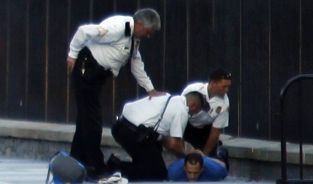 U.S. Secret Service officers detain a man after he reportedly threw firecrackers over the fence of the White House in Washington September 16, 2013. A man threw firecrackers over the White House's north fence line on Monday, just hours after a deadly shoo