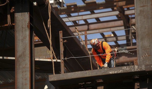 A construction worker performs labor at a residential building project in the China Basin area in San Francisco, California March 8, 2013. U.S. employers added a greater-than-expected 236,000 workers to their payrolls in February and the jobless rate fell