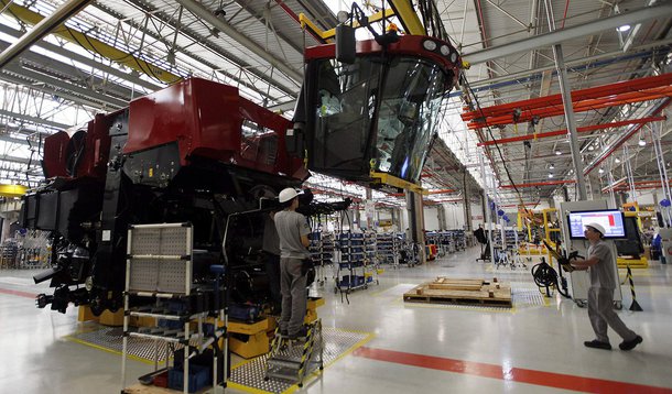 Employees work at a harvest machine assembly line at the Case Agricultural Machinery Plant in Sorocaba, 100 km (62 miles) west of Sao Paulo, September 18, 2013. For the first time in history, Brazil is expected to export more soybeans than it crushes dome