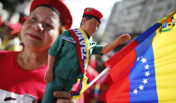A supporter of Venezuelan President Hugo Chavez attends a gathering outside Miraflores Palace in Caracas January 10, 2013. Chavez remained on his sickbed in Cuba on Thursday while supporters rally in his honour on the day he should have been sworn in for 