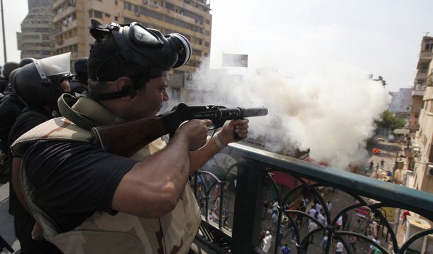 Riot police fire tear gas during clashes with members of the Muslim Brotherhood and supporters of deposed Egyptian President Mohamed Mursi, around Cairo University and Nahdet Misr Square, where they are camping in Giza, south of Cairo August 14, 2013. Egy