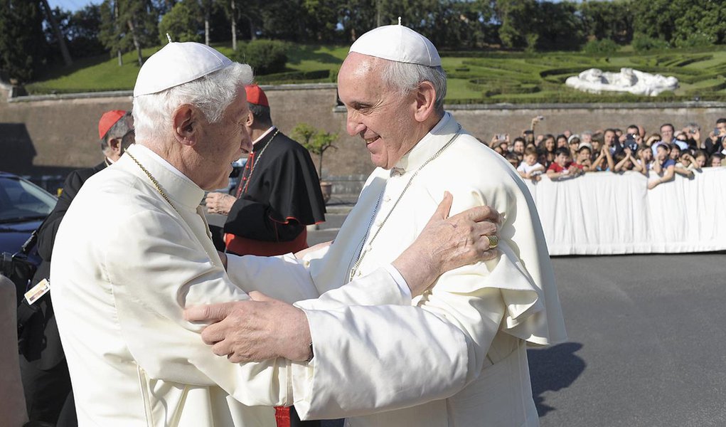 Pope Francis, right, embraces retired Pope Benedict XVI during a ceremony in the Vatican gardens July 5. During the service,  Pope Francis blessed a new statue of St. Michael the Archangel and recited separate prayers to consecrate Vatican City to St. Jos