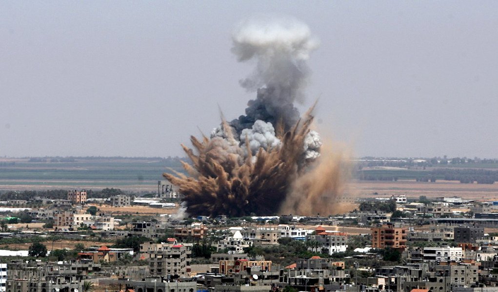 GAZA CITY, GAZA - JULY 8: Explosions and black smoke are seen after an Israeli air attack, staged at the morning hours, to the city center of Gaza City, Gaza on july 8, 2014. (Photo by Eyad Al Baba/Anadolu Agency/Getty Images)