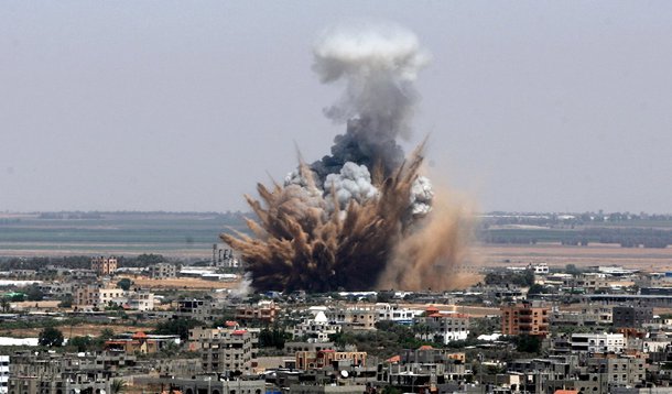 GAZA CITY, GAZA - JULY 8: Explosions and black smoke are seen after an Israeli air attack, staged at the morning hours, to the city center of Gaza City, Gaza on july 8, 2014. (Photo by Eyad Al Baba/Anadolu Agency/Getty Images)