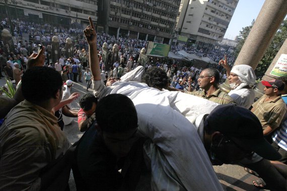An injured supporter of ousted Egyptian President Mohamed Mursi is carried into a mosque in Ramses Square in Cairo August 16, 2013. Protests by supporters of ousted Islamist President Mohamed Mursi turned violent across Egypt on Friday, with witnesses rep