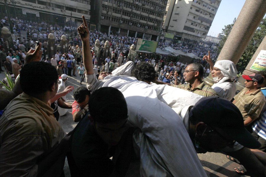 An injured supporter of ousted Egyptian President Mohamed Mursi is carried into a mosque in Ramses Square in Cairo August 16, 2013. Protests by supporters of ousted Islamist President Mohamed Mursi turned violent across Egypt on Friday, with witnesses rep