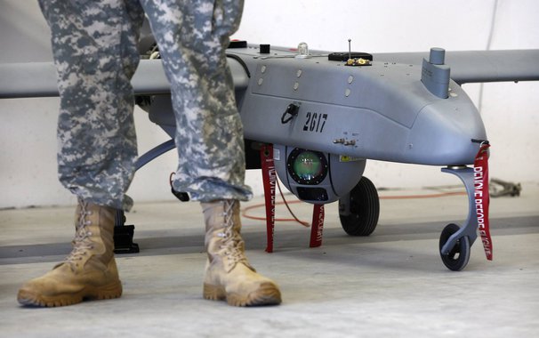 A soldier stands in front of a 'Shadow' Unmanned Aerial System during an official presentation by the German and U.S. Unmanned Aerial Systems (UAS) at the U.S. military base in Vilseck-Grafenwoehr October 8, 2013. The drone has a wing-spread of 6.90 metre