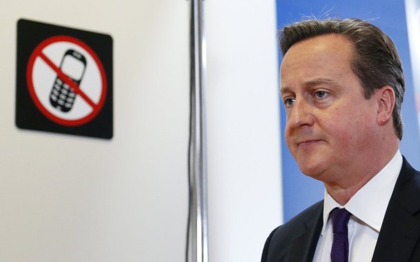 Britain's Prime Minister David Cameron leaves a news conference during a European Union leaders summit in Brussels October 25, 2013. Cameron pressed European leaders on Friday to scrap red tape that London says is strangling small companies, but won from 