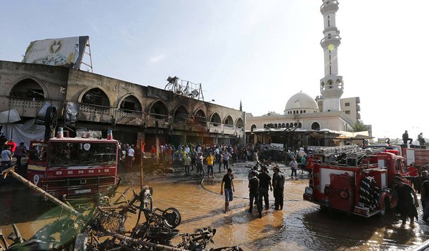 Civil Defence members and residents gather at the site of one of two mosques hit by explosions in Lebanon's northern city of Tripoli, August 23, 2013. Twin explosions outside two mosques killed at least 27 people and wounded hundreds in apparently coordin