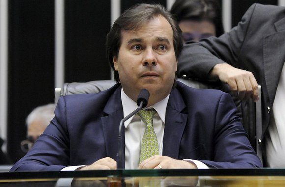 Após a agência de classificação de risco Standard &amp; Poor’s reduzir nesta quinta-feira a nota de crédito da dívida soberana do Brasil para BB- ante a nota anterior BB, o presidente da Câmara dos Deputados, Rodrigo Maia (DEM-RJ), atribuiu a mudança no rating às denúncias apresentadas pela Procuradoria-Geral contra Michel Temer neste ano; "O que pesou foram duas denúncias que atrasaram a vota da] Previdência. De fato, o governo ficou fraco após as denúncias", afirmou o democrata, evitando jogar o peso do rebaixamento na Câmara