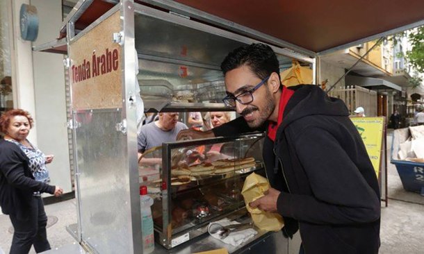 Após o sucesso do 'esfihaço', o refugiado sírio Mohamed Ali Abdelmoatty Ilenavvy, de 33 anos, vítima de xenofobia em Copacabana, pretende comprar um food truck para expandir seu negócio de quitutes além do Rio de Janeiro; convocado nas redes sociais, o ato solidário formou longas filas durante todo o dia de ontem (12) na Rua Santa Clara; "Estou muito feliz. Muito mesmo. Sou a pessoa mais feliz do mundo hoje. E estou muito orgulhoso porque vivo no Brasil, amo todo mundo e fiquei muito surpreso com o movimento. Já perdoei aquele homem (o agressor)", disse Mohamed; ele afirmou que foi o dia mais lucrativo desde que chegou ao Rio, há três anos