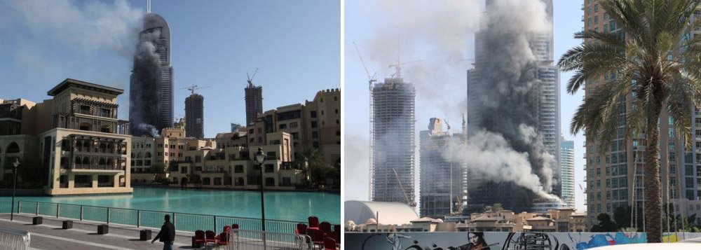 Bombeiros aparentemente apagaram a maior parte do fogo que repentinamente tomou conta de um dos arranha-céus mais importantes de Dubai durante a passagem do ano, segundo relataram testemunhas; a fumaça branca, no entanto, ainda sai da torre do hotel Address Downtown Dubai, cujo edifício tem 63 andares; equipes da defesa civil extinguiram a maior parte das chama; de acordo com a polícia de Dubai, o prédio foi esvaziado e que apenas 14 pessoas ficaram levemente feridas, mas um médico no local afirmou que 60 pessoas foram tratadas por inalação de fumaça e problemas causados pelo tumulto na tentativa de fugir do local