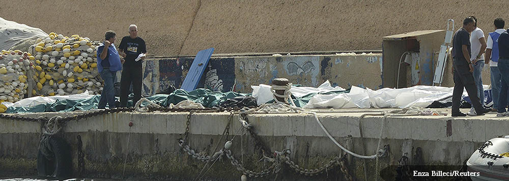 Body bags containing African migrants, who drowned trying to reach Italian shores, lie in the harbour of Lampedusa October 3, 2013. At least 94 people died and scores were missing after a boat carrying migrants from Africa sank off the Sicilian island of 