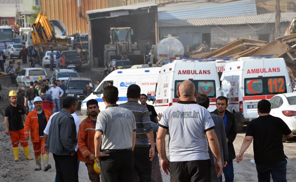 Rescue workers and ambulances at the entrance of the mine after an explosion and fire at a coal mine in Soma, in western Turkey, Tuesday, May 13, 2014.  An explosion and fire at a coal mine in western Turkey killed at least one miner Tuesday and left up t