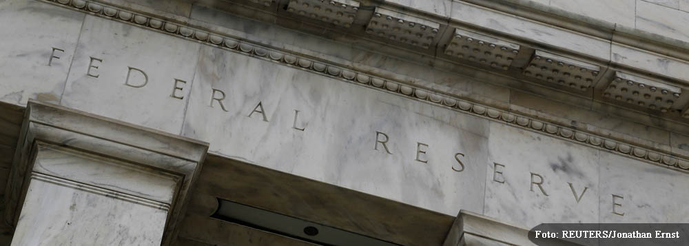 An eagle tops the U.S. Federal Reserve building's facade in Washington, July 31, 2013. The U.S. Federal Reserve likely will decide at the end of a policy meeting on Wednesday to continue buying bonds at an $85 billion monthly pace, but it could alter an a