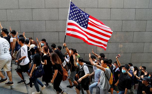 Manifestantes em Hong Kong, China, com bandeira dos Estados Unidos.