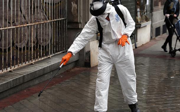 Homem desinfeta rua em Madri, Espanha