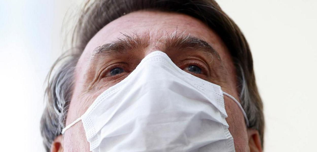 Brazil's President Jair Bolsonaro wearing a protective mask speaks with journalists, amid the coronavirus disease (COVID-19) outbreak, at the Planalto Palace, in Brasilia, Brazil May 12, 2020.