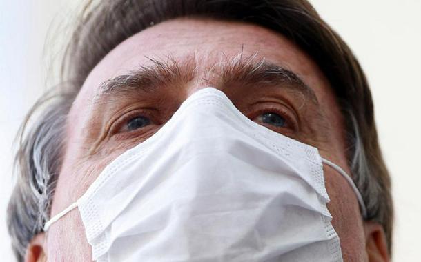 Brazil's President Jair Bolsonaro wearing a protective mask speaks with journalists, amid the coronavirus disease (COVID-19) outbreak, at the Planalto Palace, in Brasilia, Brazil May 12, 2020.