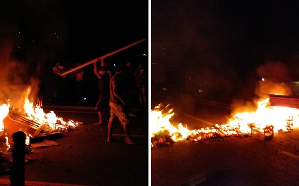 Manifestantes queimam materiais e interditam Rio-Santos em protesto contra feriado prolongado em SP