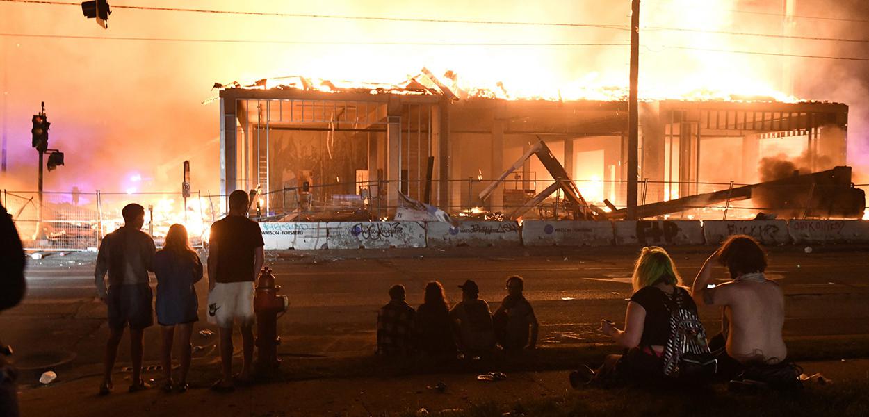 Protesters gather near the Minneapolis Police third precinct to watch a construction site burn after a white police officer was caught on a bystander's video pressing his knee into the neck of African-American man George Floyd, who later died at a hospital, in Minneapolis, Minnesota, U.S. May 28, 2020.
