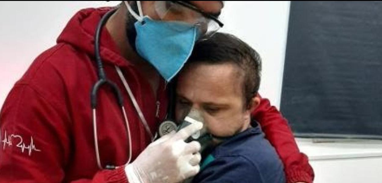 Enfermeiro abraçou paciente com síndrome de Down para tranquilizá-lo enquanto ele recebia oxigênio.