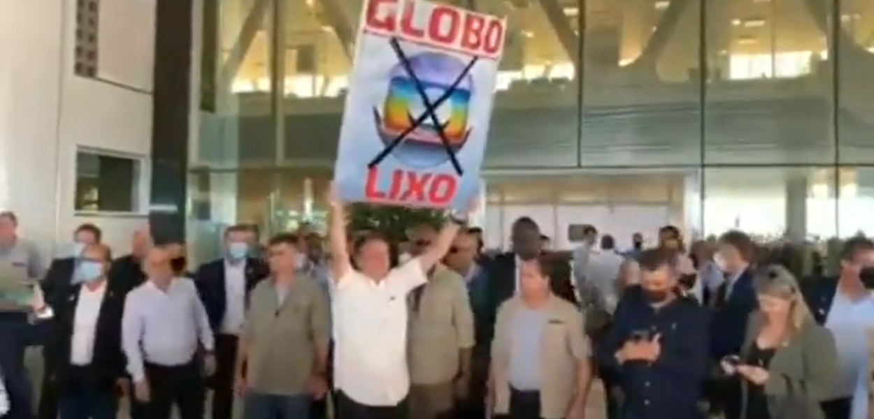 Bolsonaro ergue cartaz com mensagem "Globo lixo"