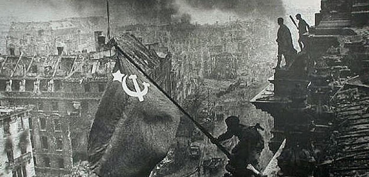 A bandeira soviética içada no telhado do Reichstag, foto histórica de Yevgeny Khaldei