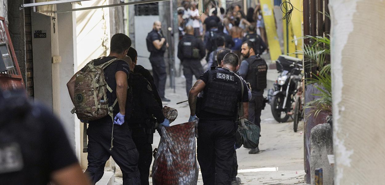 Policiais carregam corpo durante operação na favela do Jacarezinho 06/05/2021