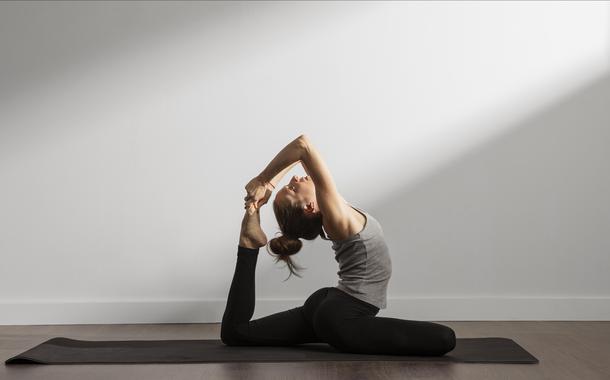 Image of young sports lady at the beach make meditation exercises.