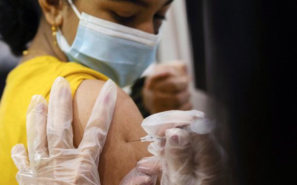 Menina recebe dose da vacina contra Covid-19 da Pfizer-BioNTech