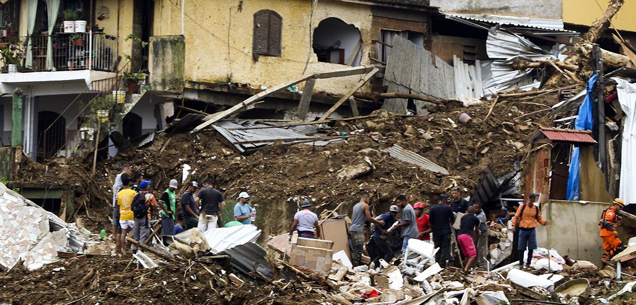 Bombeiros, moradores e voluntários trabalham no local do deslizamento no Morro da Oficina, após a chuva que castigou Petrópolis, na região serrana fluminense