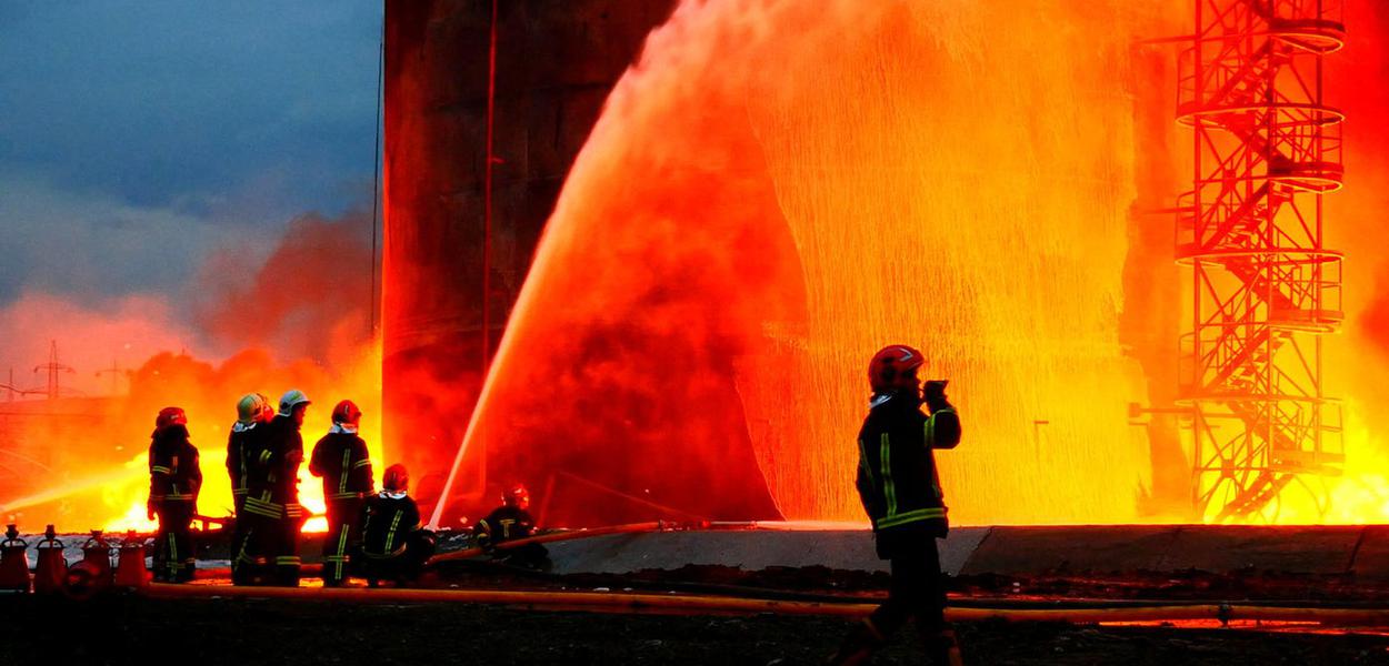 Rescuers work at a site of fuel storage facilities hit by cruise missiles, as Russia's attack on Ukraine continues, in Lviv, in this handout picture released March 27, 2022.  Press service of the State Emergency Service of Ukraine/Handout via REUTERS