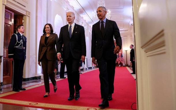 O presidente dos EUA, Joe Biden, é ladeado pelo vice-presidente Kamala Harris e o ex-presidente Barack Obama ao chegar para fazer comentários sobre o Affordable Care Act e o Medicaid, na Sala Leste da Casa Branca em Washington, EUA, 5 de abril de 2022
