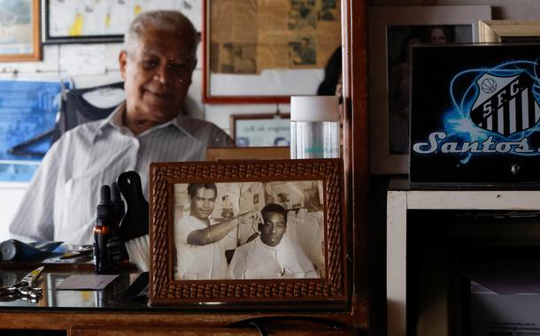 João Araújo, conhecido como Didi, 84 anos, que foi cabeleireiro de Pelé, olha para uma foto sua com o Rei do Futebol - 30/12/2022