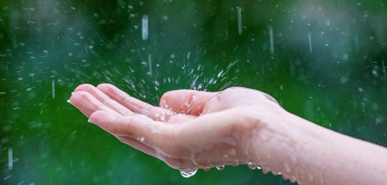 Close-up of wet female hands in rain