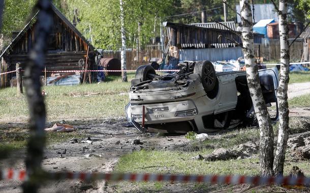 A view shows a damaged white Audi Q7 car lying overturned on a track next to a wood, after Russian nationalist writer Zakhar Prilepin was allegedly wounded in a bomb attack in a village in the Nizhny Novgorod region, Russia, May 6, 2023. REUTERS/Anastasia Makarycheva