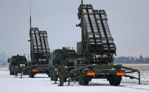 FILE PHOTO: Serviceman patrols in front of the Patriot air defence system during Polish military training on the missile systems at the airport in Warsaw, Poland February 7, 2023. REUTERS/Kacper Pempel